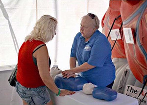 AHEC staff demonstrate CPR at a community event.