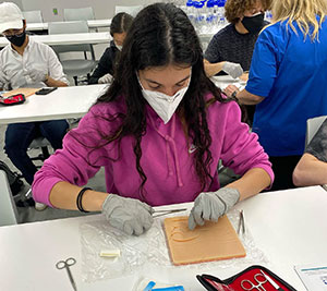 Participants practice suturing skills at Knox College.
