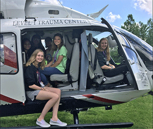 Rural health Careers participants pose in a Level 1 trauma center helicopter.