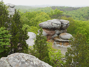Striking rock formation rises above treetops in Shawnee National Forest.